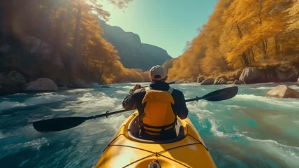 Fotobehang Extreme sport kayak sails mountain river with sun light. Rafting, whitewater kayaking. © Adin