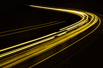 yellow car lights at night. long exposure - obrazy, fototapety, plakaty