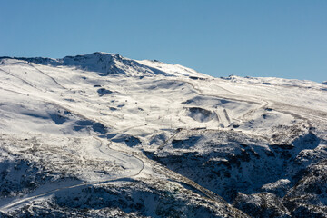 panoramic view of ski resort in sierra nevada, skiers along the slopes