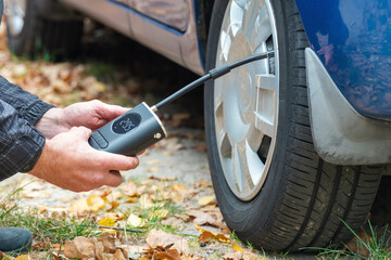 Inflating car tires with a portable wireless air pump outdoor