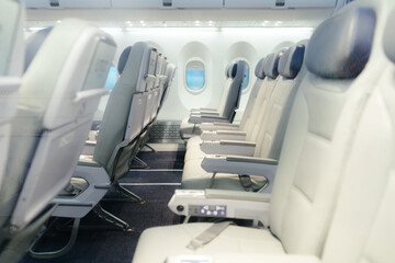 Empty passenger seats in cabin of the aircraft. Plane interior. Business class in commercial...