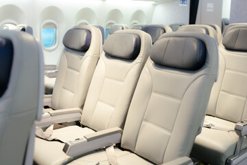 Fototapeta premium Empty passenger seats in cabin of the aircraft. Plane interior. Business class in commercial transport