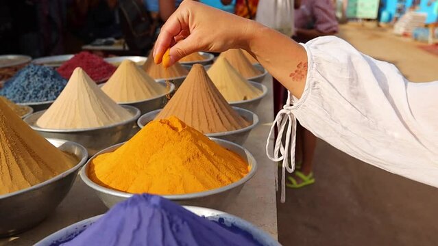 Woman hand touching Pyramid of spices on Egyptian market in Aswan Egypt