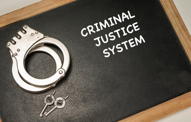 Criminal justice system text with handcuff and keys