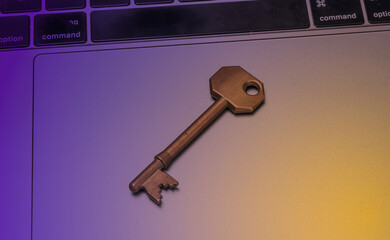 Lock key isolated on laptop - modern security concept