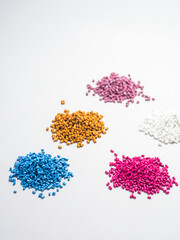 various colored masterbatch granules isolated on a white background, this polymer is a colorant for...