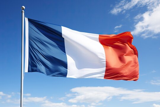 The tricolor French flag proudly waving in a clear blue sky, symbolizing national pride