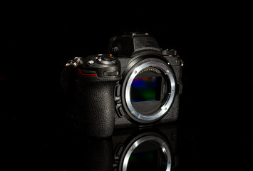 Digital sensor mirrorless camera body with reflection on dark background