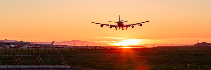 Commercial Airliner landing at Vancouver International Airport. Sunset