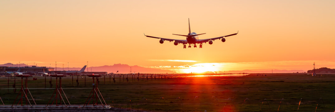 Commercial Airliner landing at Vancouver International Airport. Sunset
