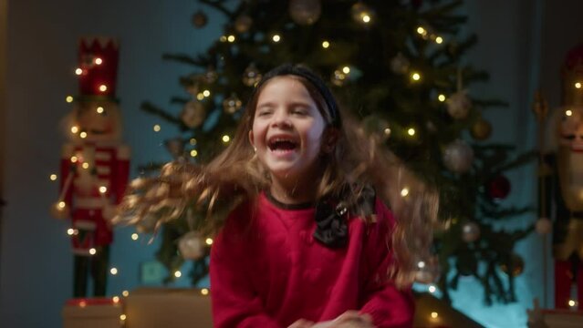 Happy girl jumping and smiling fot Christmas gift 
