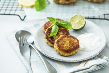 Traditional homemade fish cakes with tlemon and sour cream