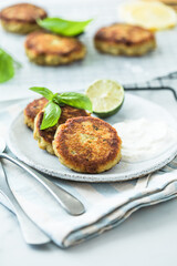 Traditional homemade fish cakes with tlemon and sour cream
