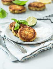 Traditional homemade fish cakes with tlemon and sour cream