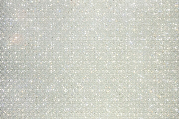 Sparkling background made of thousand of small white lamps. Discotheque style. Text space. Indoor...