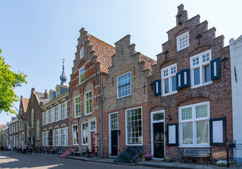 Fototapeta na wymiar Beautiful old buildings with ornate facades on the Kaai in the historic town of Veere in Zeeland