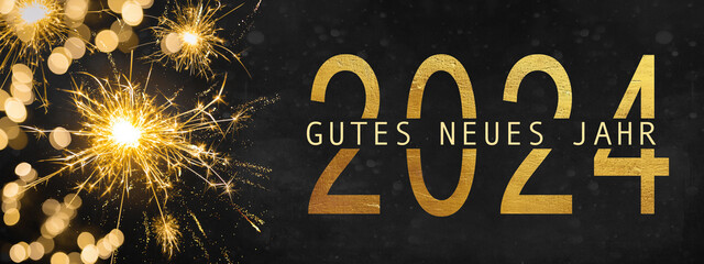 Goldenes Feuerwerk auf schwarzemNacht Himmel Hintergrund, Text Gutes neues Jahr 2024 mit...