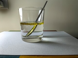 A glass cup of water and oil