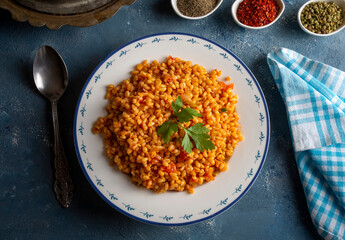 Traditional turkish bulgur pilaf with tomato sause in plate (Turkish name; meyhane pilavi)