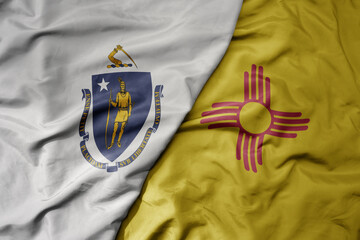 big waving colorful national flag of new mexico state and flag of massachusetts state .