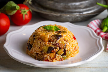 Traditional delicious Turkish food; Bulgur pilaf with eggplant and vegetables. (Turkish name;...