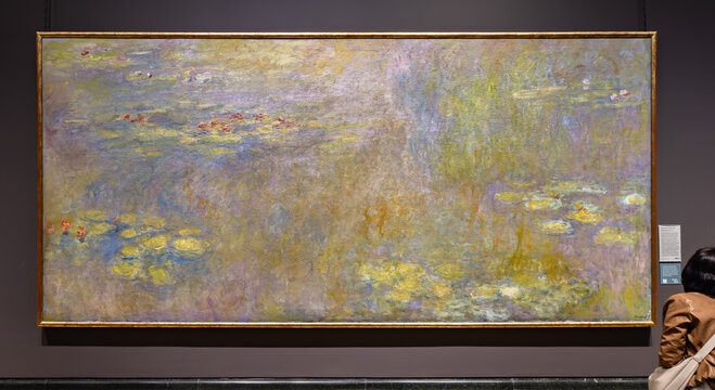 London, UK - May 19, 2023: Painting Water Lilies that is a series of approximately 250 oil paintings by French Impressionist Claude Monet, exposed at National Gallery of London