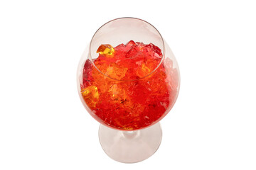 Sweet fruit jelly dessert in a glass isolated on a white background.