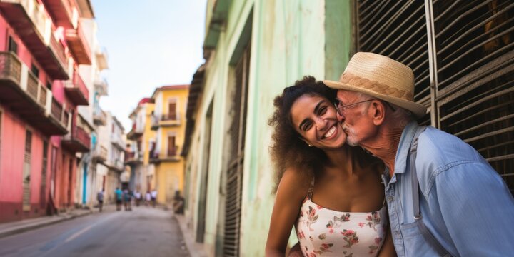 Old male tourist having fun with a Latin Caribbean young woman