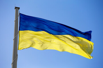 National flag of Ukraine against blue sky