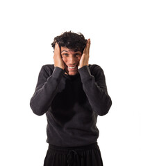 Young Man Forcing His Mouth To Smile By Pushing Lips and Cheeks With Hands in studio shot on white.