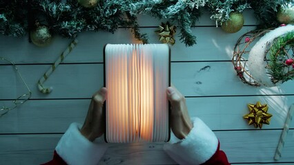 Wooden table with Santa Opening Magic book