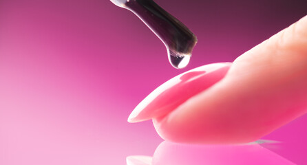 Applying Nail polish, pink shellac UV gel, varnish, manicure process concept in beauty salon....