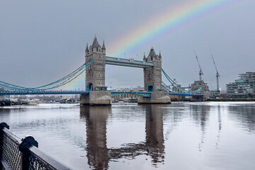 Tower Bridge connecting London with Southwark on the Thames River and a rainbow in the sky