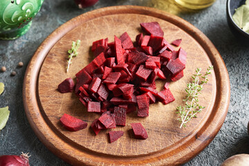 Preparation of fermented beetroot - sliced beet on a cutting board - obrazy, fototapety, plakaty