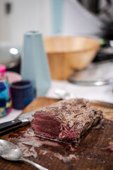 Raw beef piece for cooking on a cutting wooden board