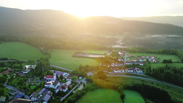 Early rays of sunshine in small Bavarian village with only few houses