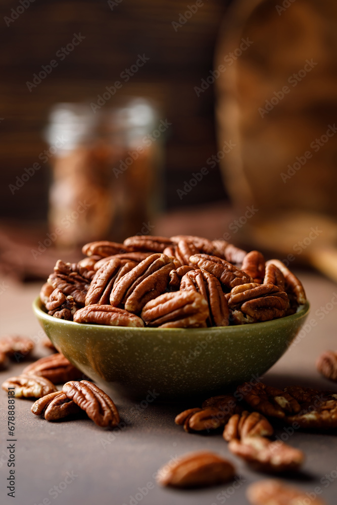 Canvas Prints Pecan nuts in a bowl on a brown background