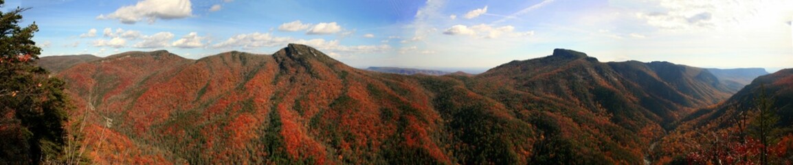 Panoramic of the lush Linville Gorge in autumn with floating clouds above, North Carolina