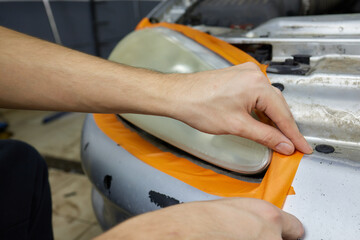 Big headlight cleaning on the car with power buffer machine at service station ,Before and after...
