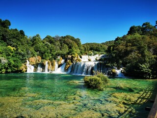 Beautiful waterfalls surrounded by green vegetation in Krka National Park. Dalmatia, Croatia.