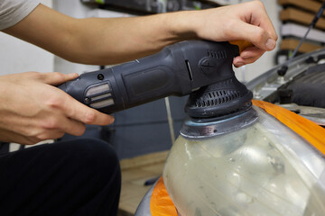 Big headlight cleaning on the car with power buffer machine at service station ,Before and after...