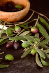 a wooden bowl with olives