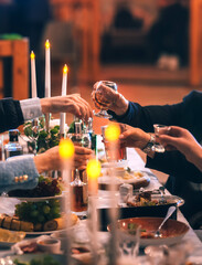 Friends drink wine. Couple toasting wineglasses in a luxury restaurant. Focus on the wineglass. Wine brunch.