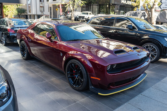 ISTANBUL, TURKEY - NOVEMBER 12, 2023: Red 2022 Dodge Challenger SRT Hemi Hellcat automobile in car gallery autopark.