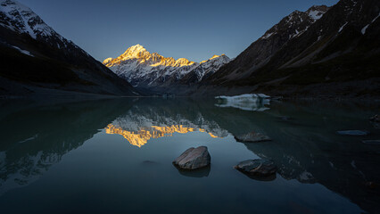 View of Hooker lake in front and Mt.Cook, the highest peak of New Zealand, in the background, during the sunset.
