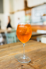 Aperol Spritz Cocktail. Alcoholic beverage based on table with ice cubes and oranges outdoors....