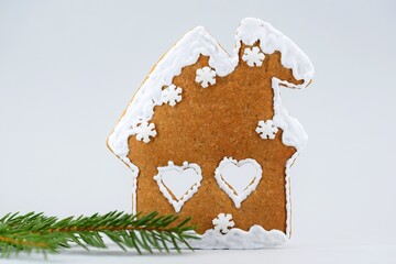 Romantic gingerbread house and spruce twig, Christmas time