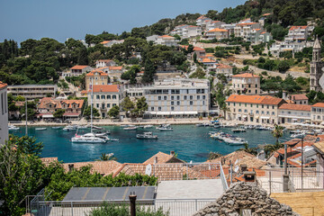 sailboats and motorboats in the bay in a small town