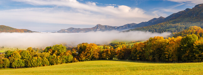 Panoramic view of autumn landscape, mountain surrounded by fog in the autumn season. The Sulov Rocks, national nature reserve in northwest of Slovakia, Europe.