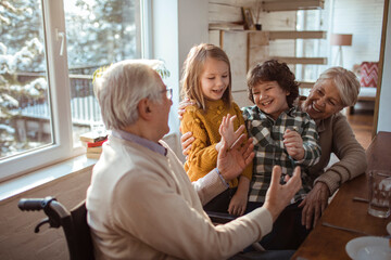 Grandparents Playing with Grandchildren Indoors
